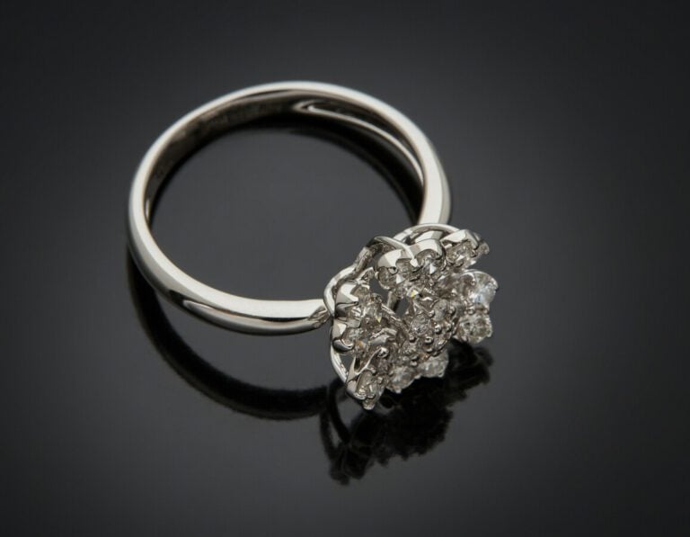 BAGUE "fleurette" en or gris (750) ajouré, serti de petits diamants taille bril…