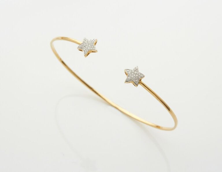BRACELET fin "deux étoiles" ouvert en or jaune (750) partiellement serti de dia…