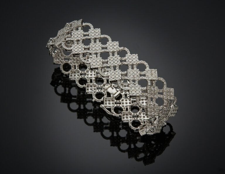 BRACELET "manchette" en or gris (585) 14 carats, ajouré à motif circulaires et…