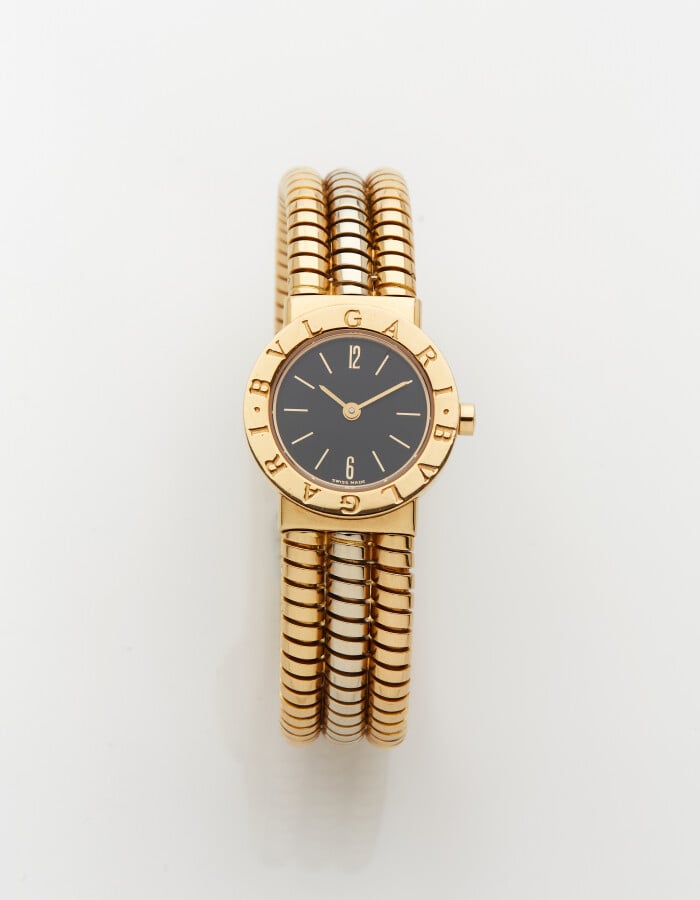 BULGARI - BRACELET MONTRE "Tubogaz" ronde en or jaune et or gris (750). Lunette…