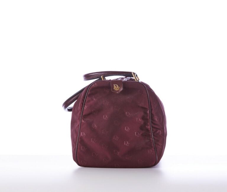 CHRISTIAN DIOR BAGAGES - 1980s/90s - SAC polochon en toile siglée et cuir borde…