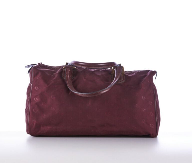 CHRISTIAN DIOR BAGAGES - 1980s/90s - SAC polochon en toile siglée et cuir borde…