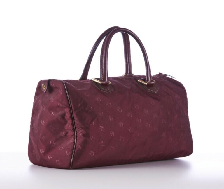 CHRISTIAN DIOR BAGAGES - 1980s/90s - SAC polochon en toile siglée et cuir borde…