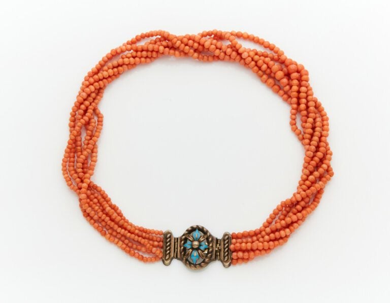 COLLIER composé de six rangs de petites perles de corail torsadés. Fermoir arti…