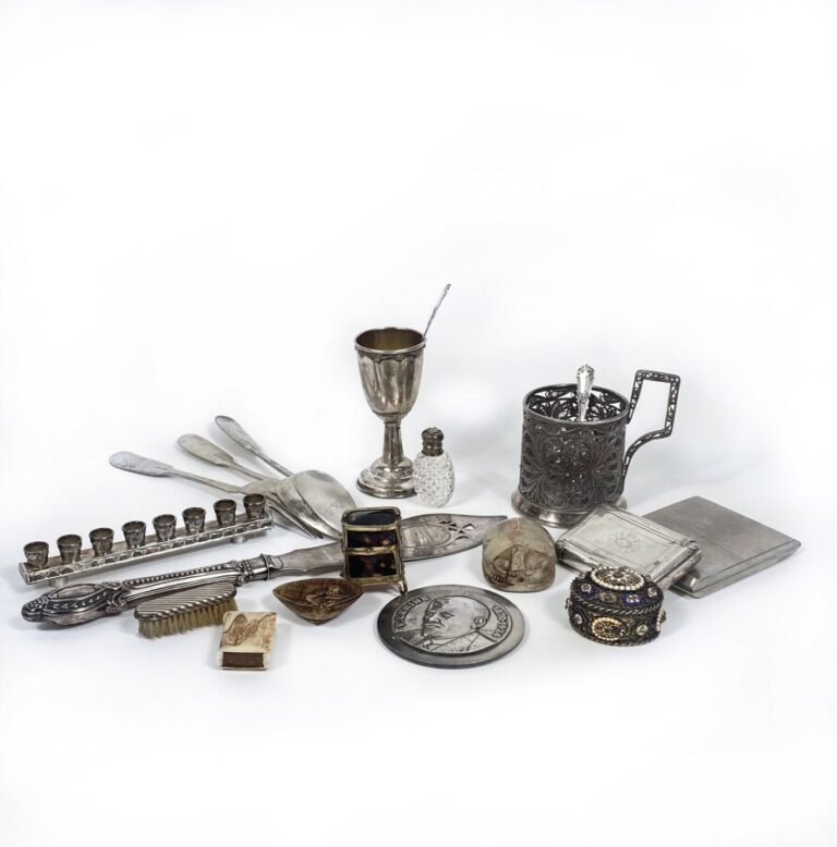 Lot comprenant : porte-tasse en métal argenté, deux cuillères et une fourchette…