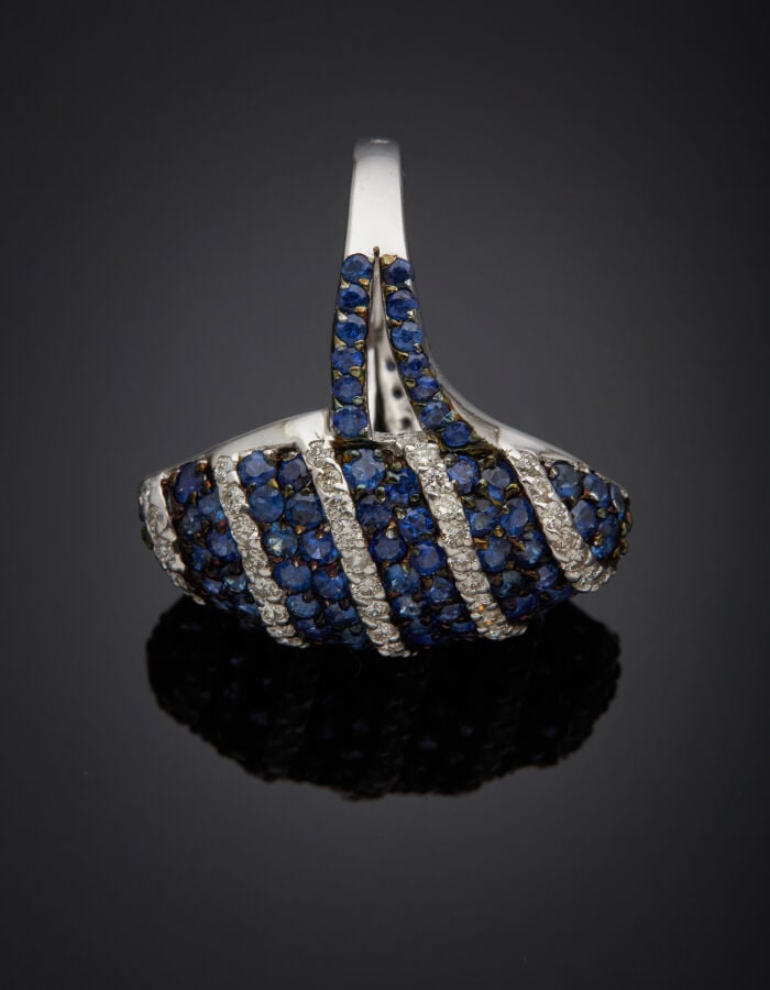 BAGUE "marquise" en or gris et or noirci (750‰) bombé, pavé d'alignements de di…