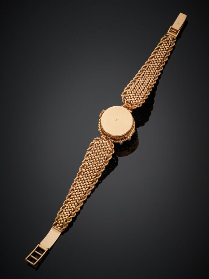 BRACELET MONTRE ronde de dame en or jaune (750‰) dissimulé sous un couvercle ci…