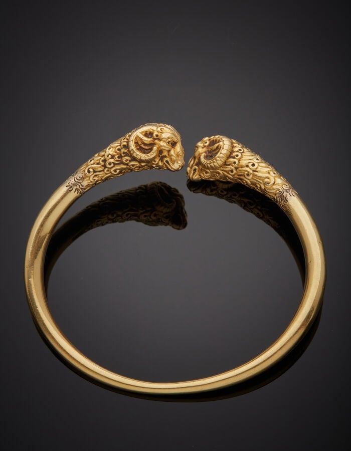 BRACELET "têtes de béliers" rigide ouvert tubulaire en or jaune (750‰) ciselé e…