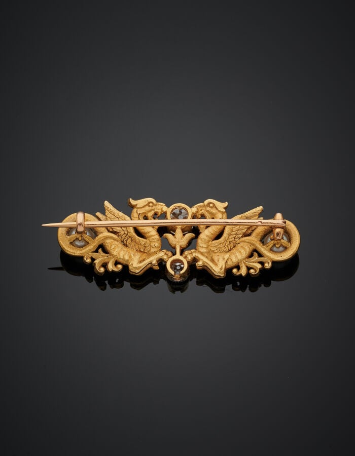 BROCHE "deux dragons" en or jaune (750‰) ciselé et sculpté, serti de deux diama…