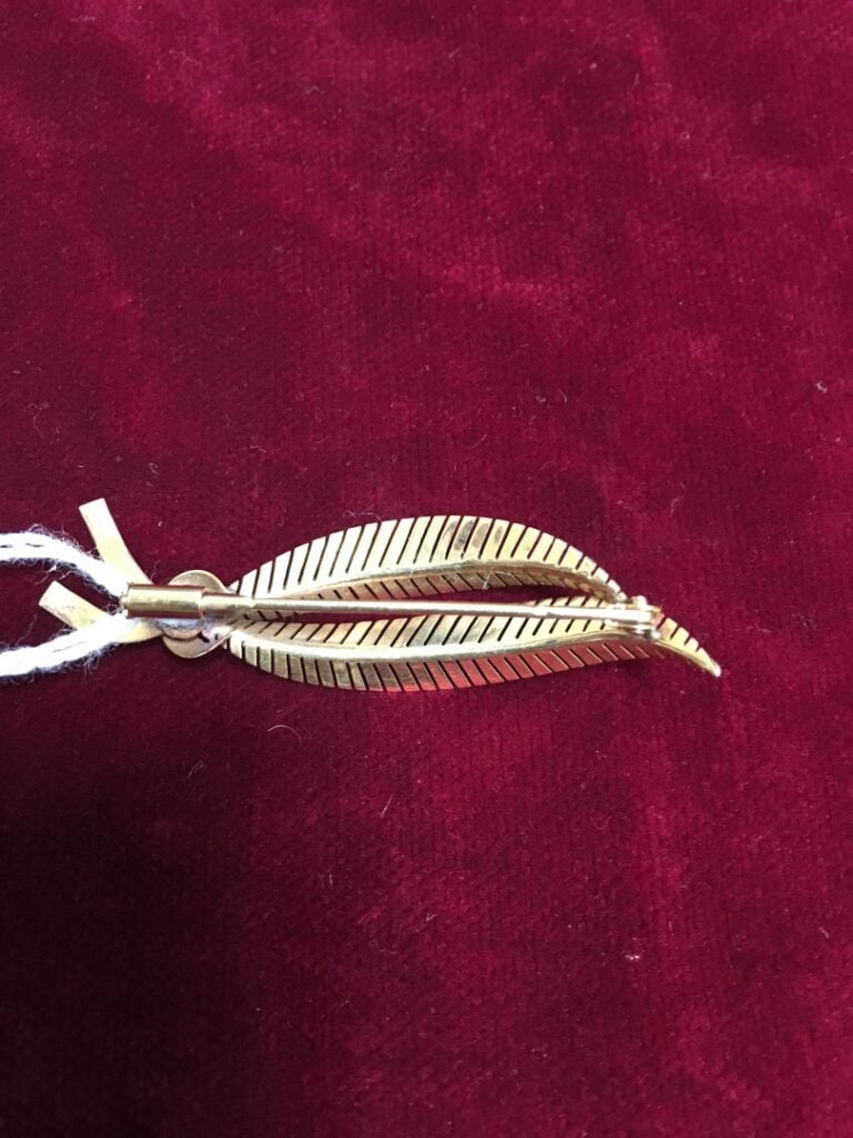 Broche "Palme" en or jaune 750 millièmes (tête d'aigle). - Poids net: 6,4 g.