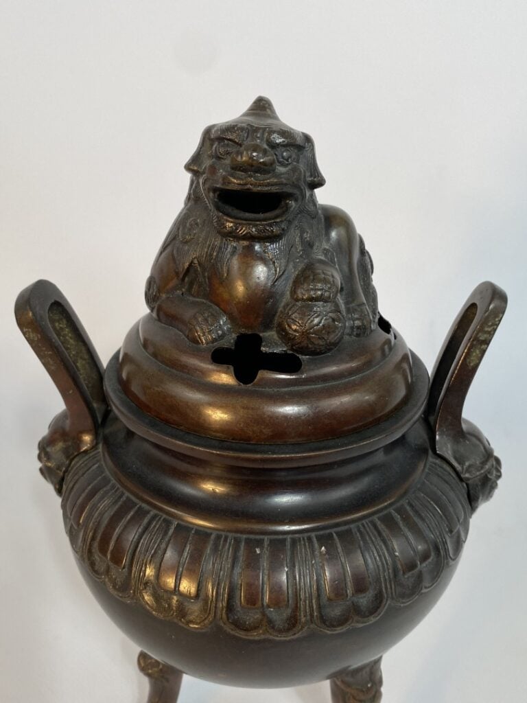 BRULE-PARFUM COUVERT EN BRONZE TRIPODE - Chine, - Le couvercle ajouré est surmo…