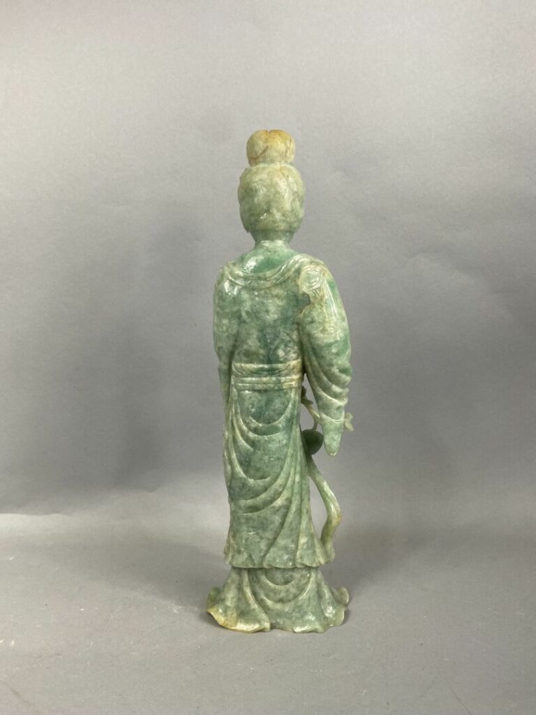 CHINE, XXème - Geisha en jade sculpté tenant une pêche de longévité dans la mai…