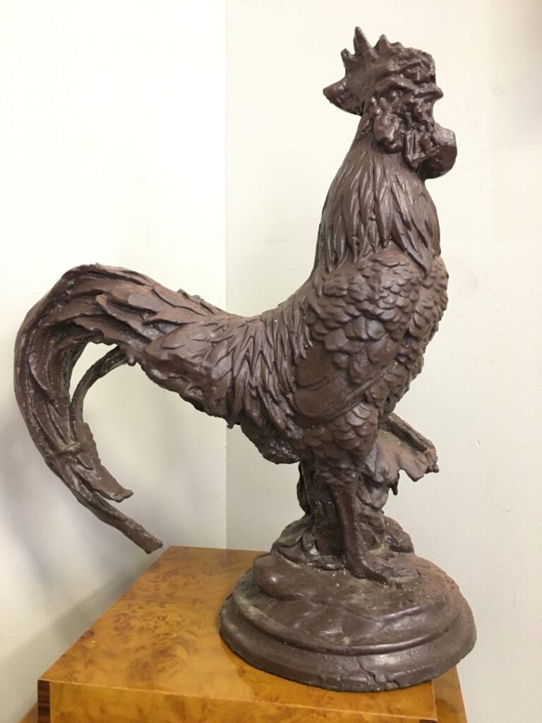 Coq debout en fonte à patine brune. - Hauteur: 45 cm.