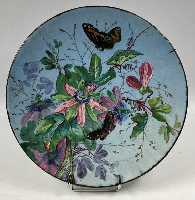 Deux grands plats en faïence à décor polychrome de fleurs et papillons - L'un s…