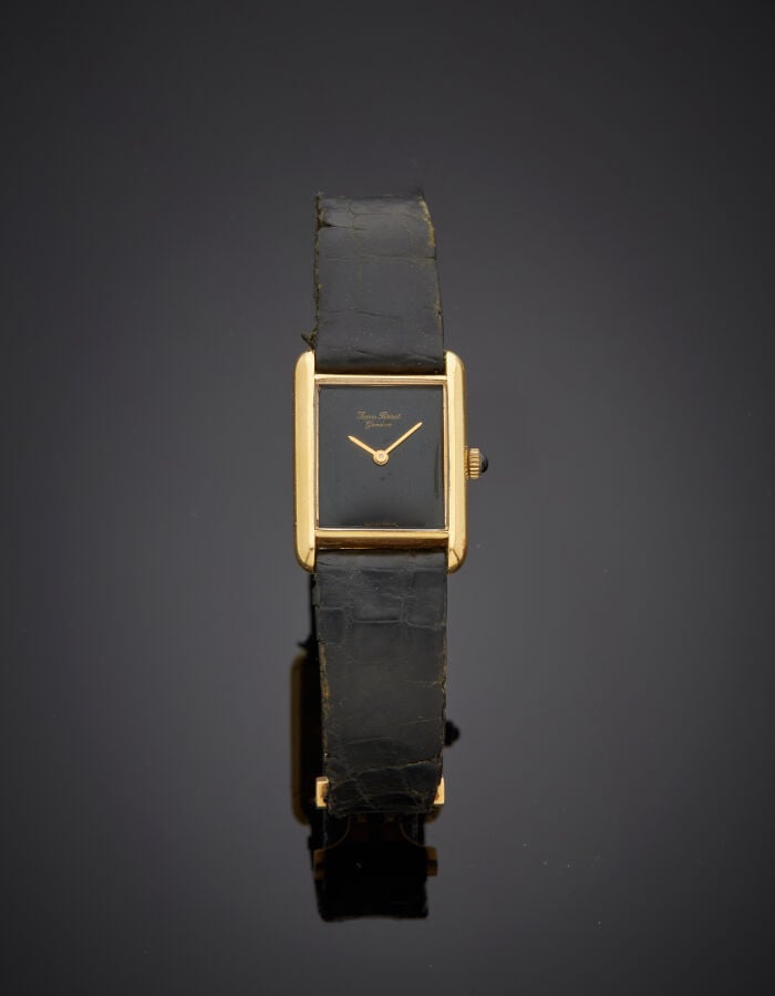 JEAN PERRET - BRACELET MONTRE rectangulaire en or jaune (750‰). Cadran noir. Mo…