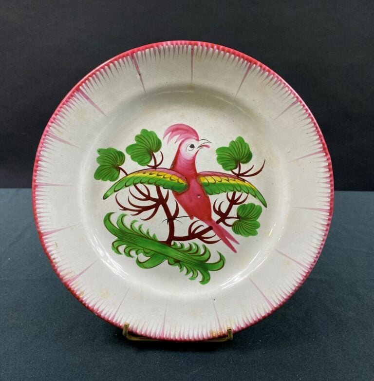 LES ISLETTES - Assiette à décor polychrome d'un oiseau posé sur une branche au…