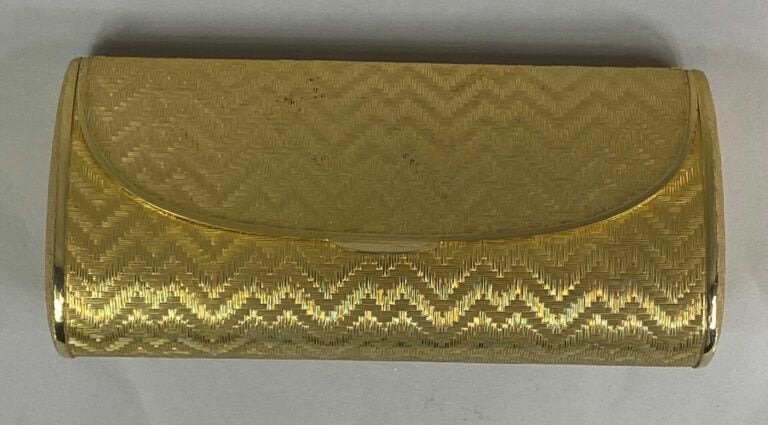 Minaudière en métal doré tressé à motifs de chevrons sur fond partiellement ama…