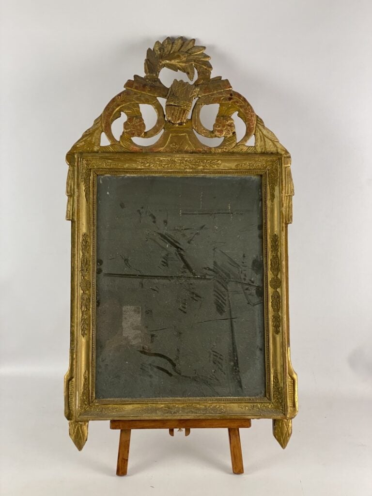Miroir à fronton en bois et stuc doré à décor de frises de raies de coeur et pa…