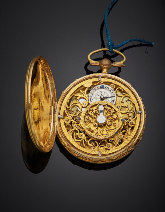 MONTRE de POCHE en métal doré, carrure facettée. Cadran squelette bordé d'émail…