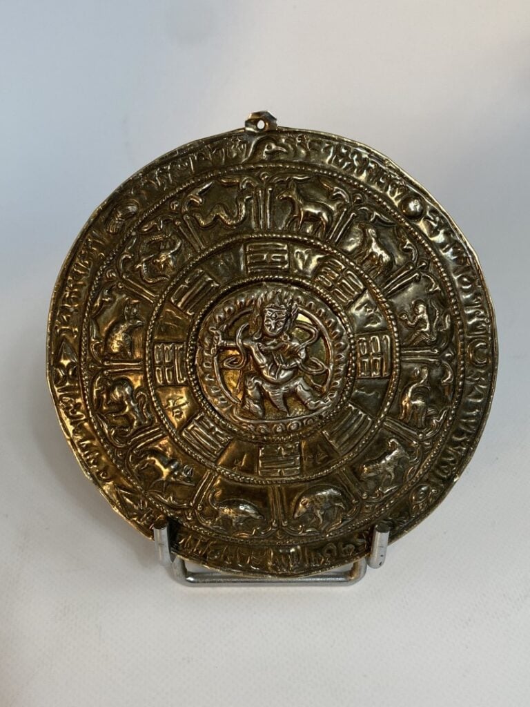 PLAQUE OVALE EN ARGENT - Tibet ? - Dans un médaillon central une divinité se te…