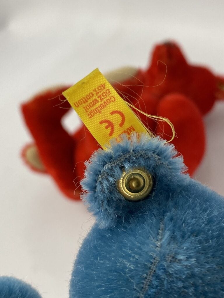 STEIFF - Lot de deux ours en peluche, l'un bleu l'autre rouge - H: 14 cm