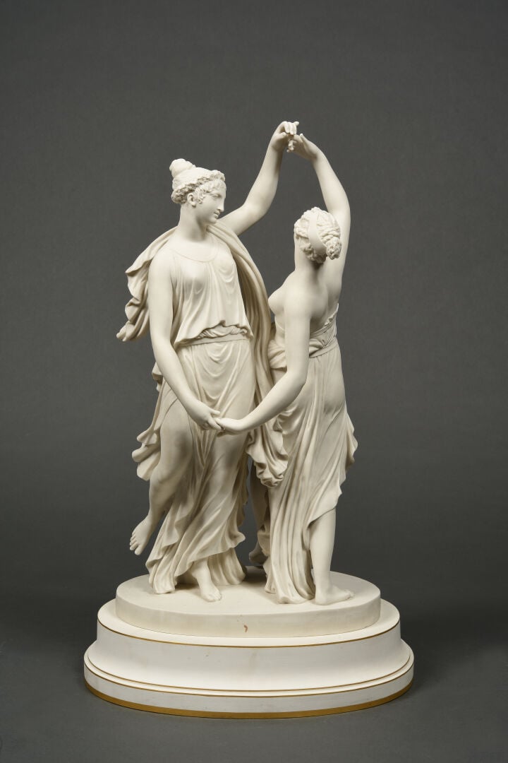 SEVRES - Grand groupe de "La Danse" sur socle circulaire à décor émaillé blanc,…