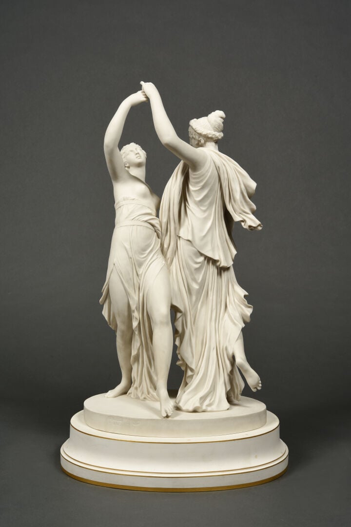 SEVRES - Grand groupe de "La Danse" sur socle circulaire à décor émaillé blanc,…