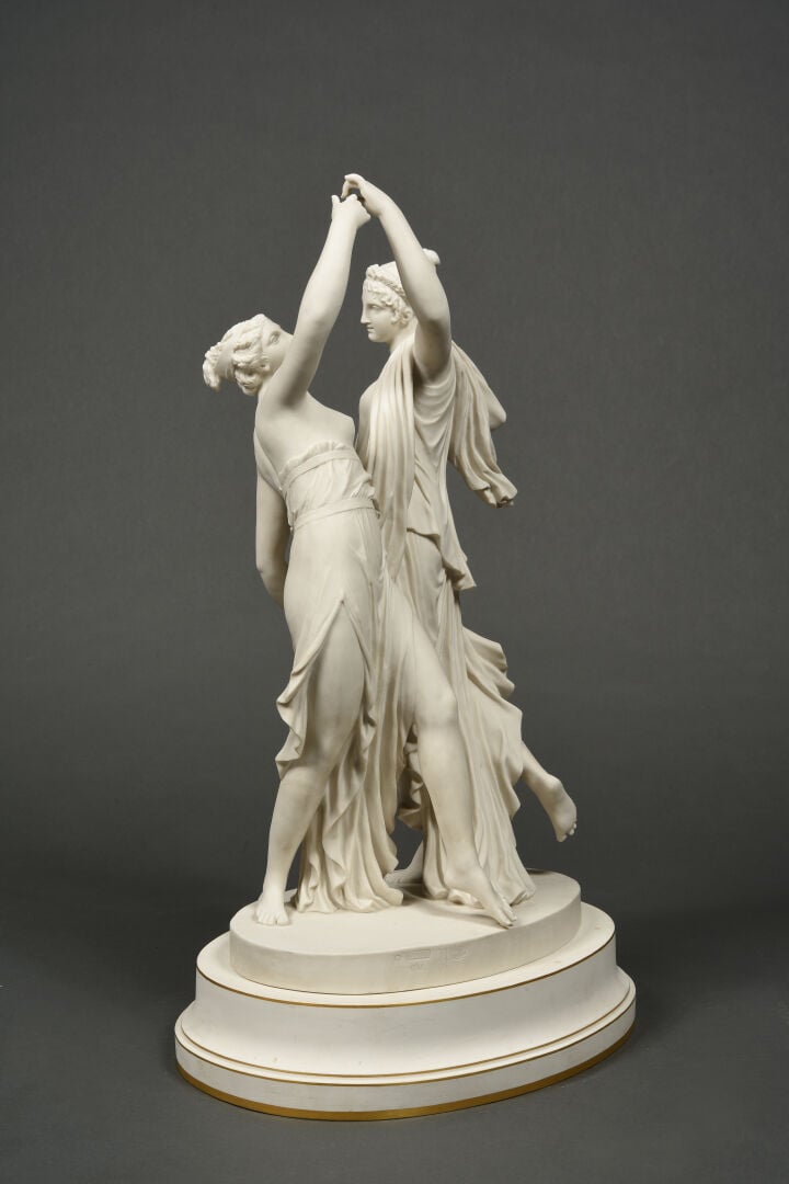 SEVRES - Grand groupe de "La Danse" sur socle circulaire à décor émaillé blanc,…