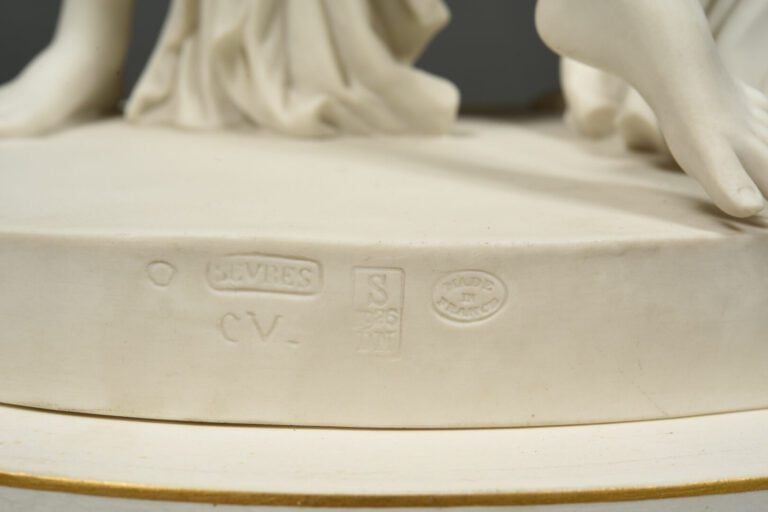 SEVRES - Grand groupe de "La Danse" sur socle circulaire à décor émaillé blanc,…