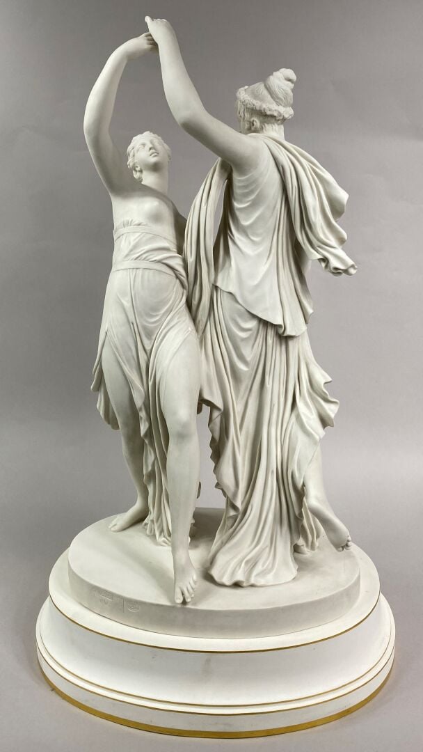 SEVRES - Grand groupe de "La Danse" sur socle circulaire à décor émaillé blanc,…
