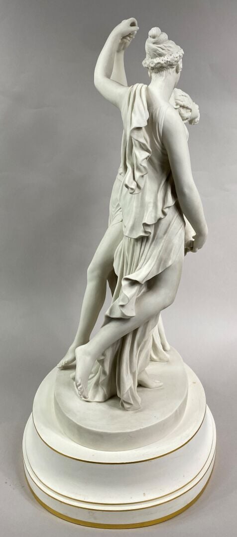 SEVRES - Grand groupe de "La Danse" sur socle circulaire à décor émaillé blanc,…
