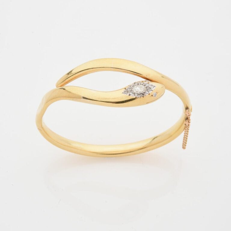 Bracelet jonc ouvrant en or jaune (750) figurant un serpent enroulé, la tête or…