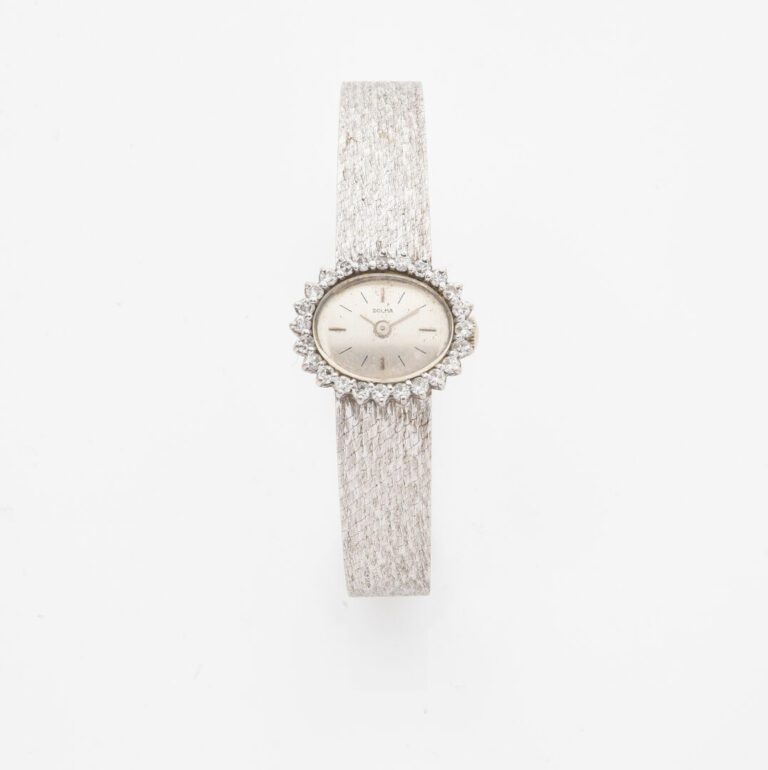 DOLMA - Montre bracelet de dame en or gris (750), boitier ovale, lunette soulig…