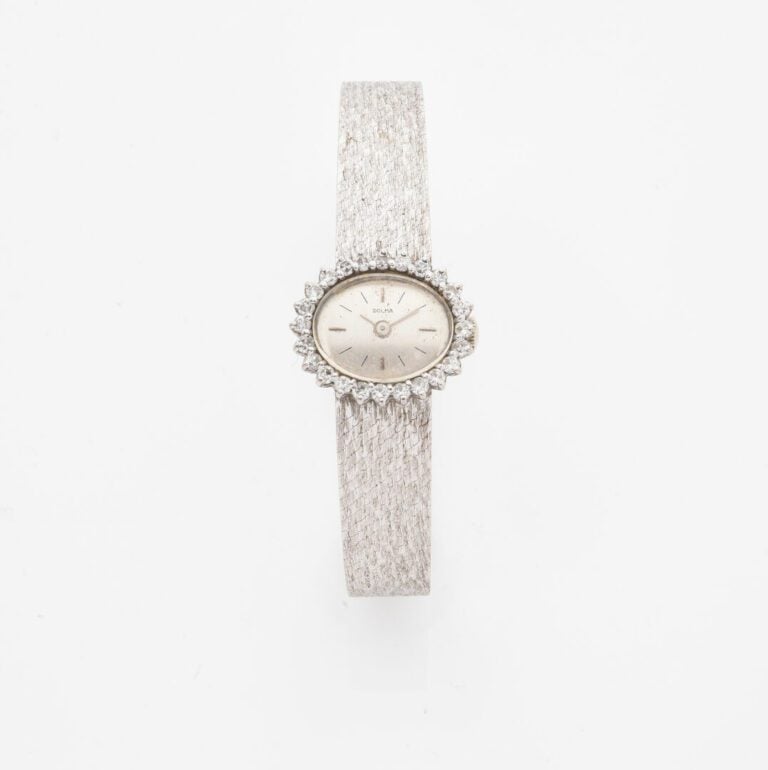 DOLMA - Montre bracelet de dame en or gris (750), boitier ovale, lunette soulig…