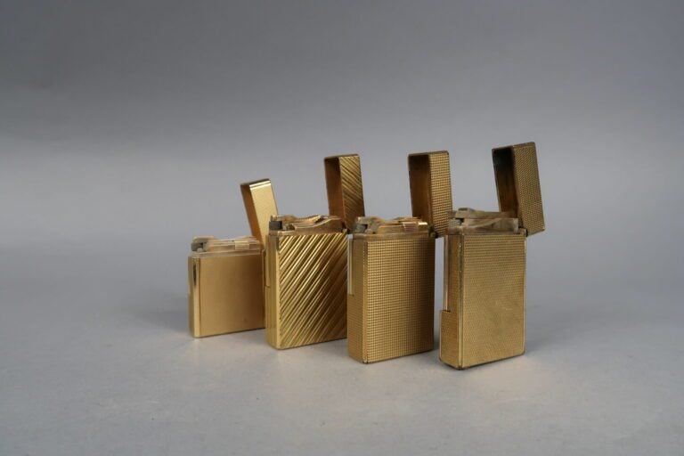 DUPONT - Ensemble de quatre briquets en métal doré à décor de pointes de diaman…