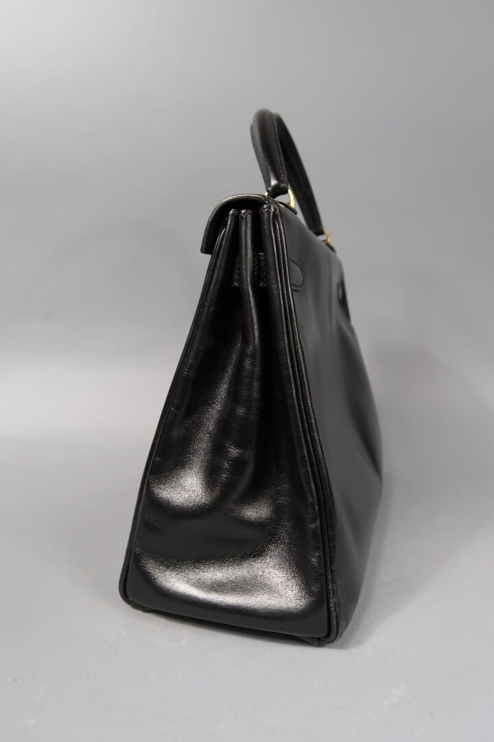 HERMES - Sac «Kelly retourné» 32cm en box noir, attributs dorés, clefs, clochet…