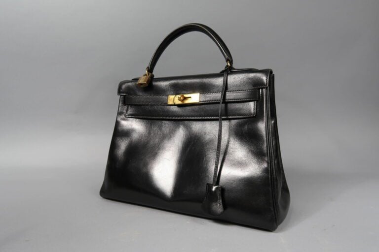 HERMES - Sac «Kelly retourné» 32cm en box noir, attributs dorés, clefs, clochet…