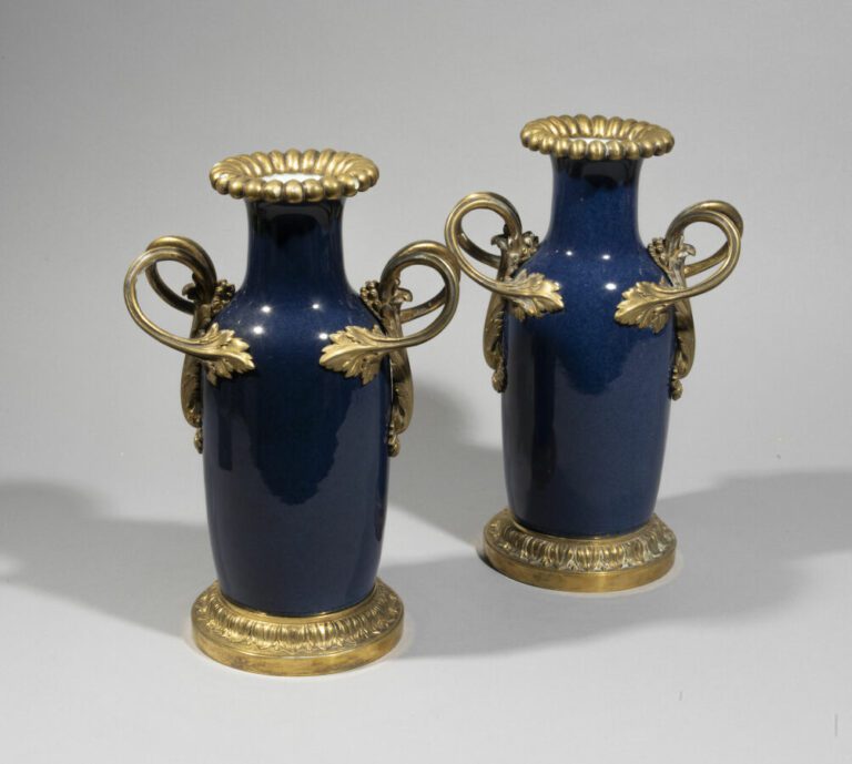 Paire de vases en porcelaine bleue à monture en bronze à motif de feuilles. - H…