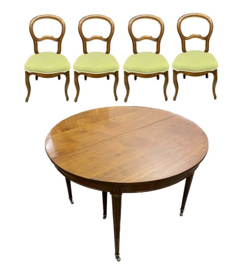 Table ronde en noyer à plateau portefeuille posant sur quatre pieds gainés bagu…