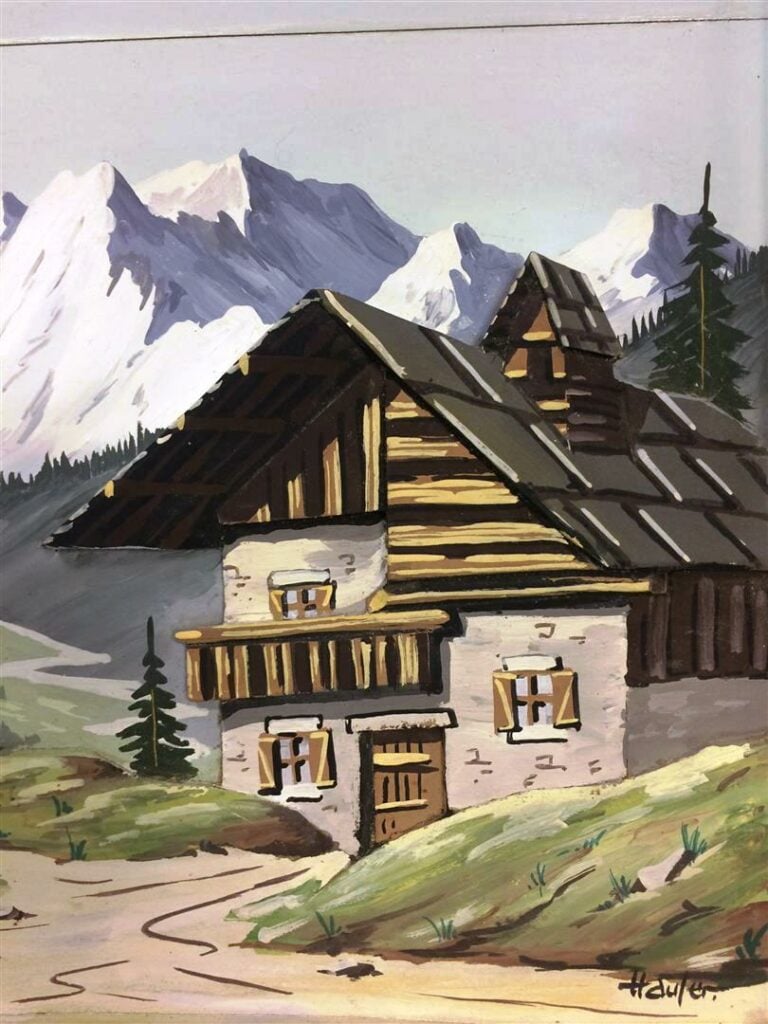 Tableau décoratif en bois sculpté représentant un paysage de montagne.