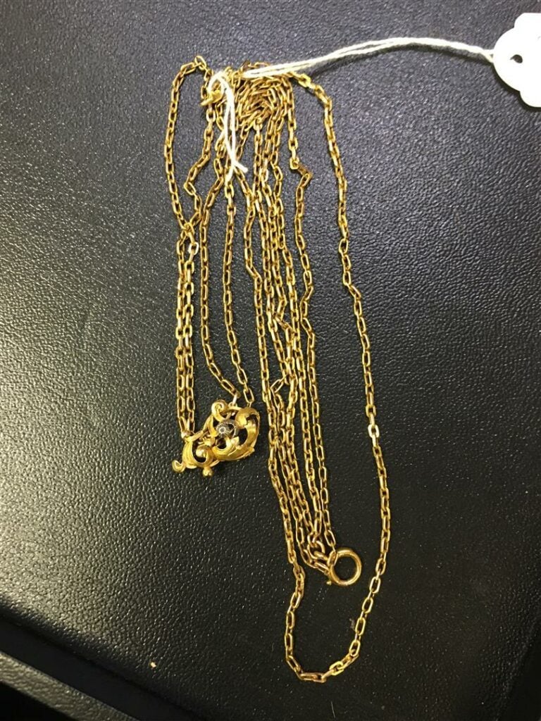 Collier en or jaune avec un pendentif en or jaune et platine à motifs feuillagé…