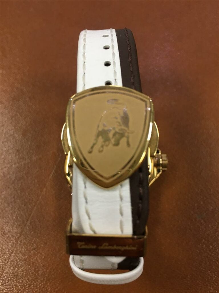 LAMBORGHINI. - Montre d'homme en métal plaqué or, cadran et bracelet en cuir bi…