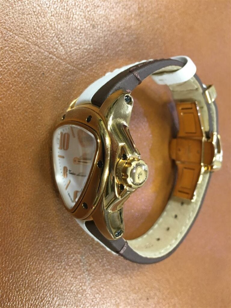 LAMBORGHINI. - Montre d'homme en métal plaqué or, cadran et bracelet en cuir bi…