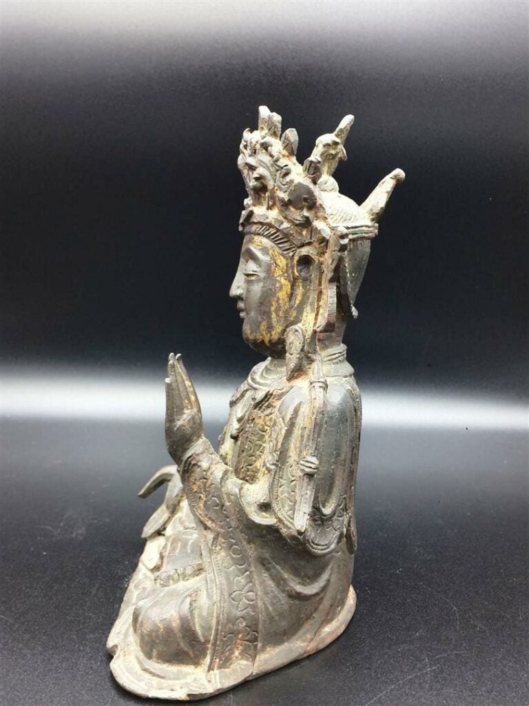 SUJET EN BRONZE A PATINE BRUNE ET OR A L'EFFIGIE DE LA DEESSE DE LA COMPASSION,…