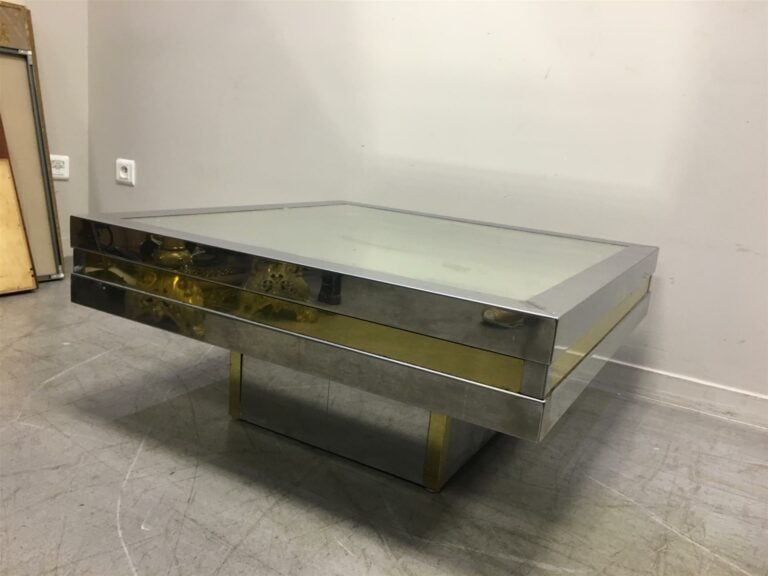 Table basse en inox et laiton, plateau à fond de glace. - Hauteur: 34 cm. ; Lon…