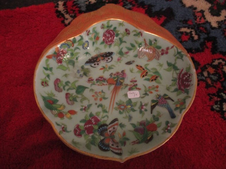 Assiette polylobée en porcelaine à décor polychrome de papillons, d'oiseaux et…