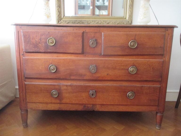 Commode en bois naturel mouluré sculpté ouvrant par quatre tiroirs sur trois ra…