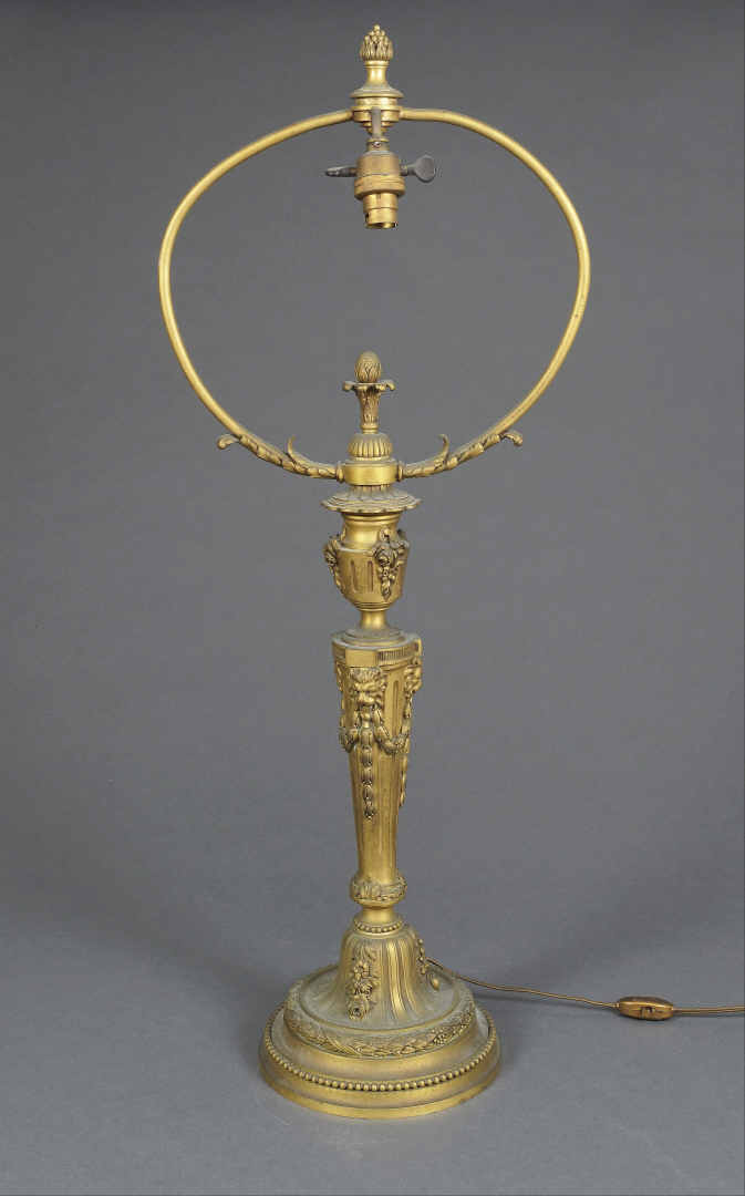 Pied de lampe en bronze doré à fût balustre cannelé et décor de têtes de lions…