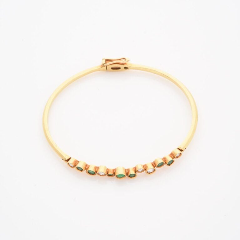 Bracelet jonc ouvrant en or jaune (750) orné d'une ligne alternée de diamants t…