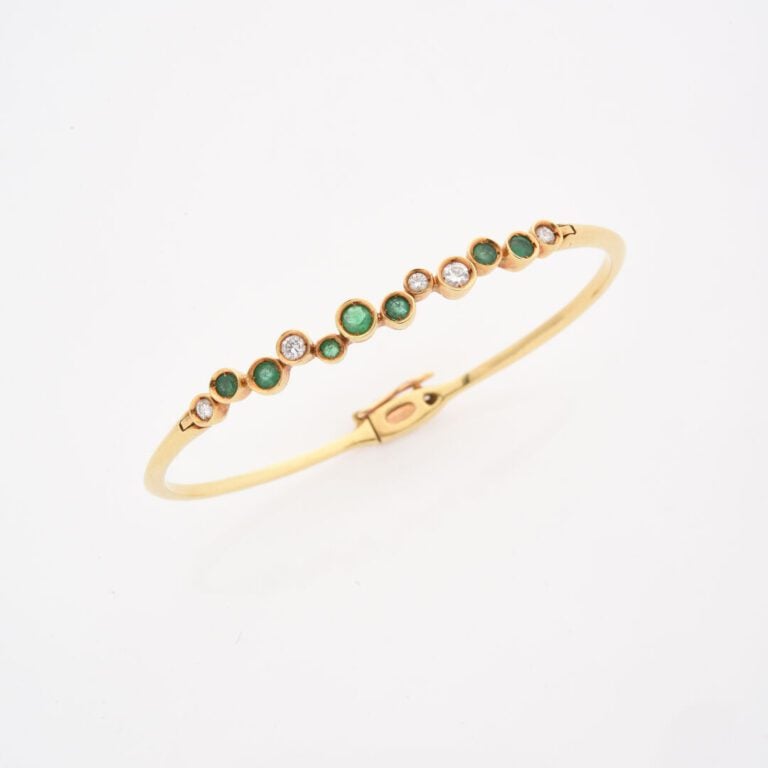 Bracelet jonc ouvrant en or jaune (750) orné d'une ligne alternée de diamants t…